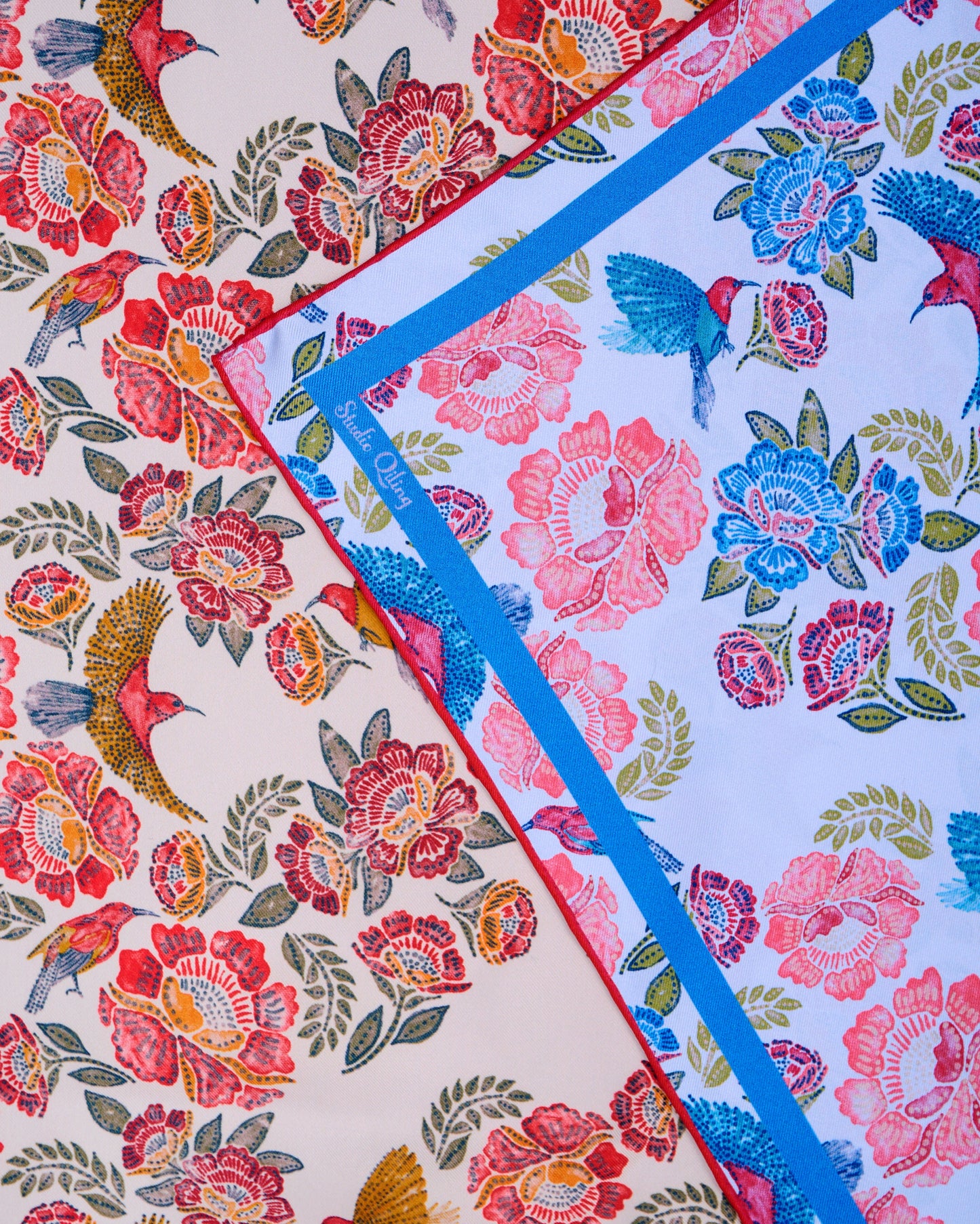 Reversible silk scard with hand-drawn batik design with flowers and crimson sunbird motifs in red on one side and sky blue on the other side
