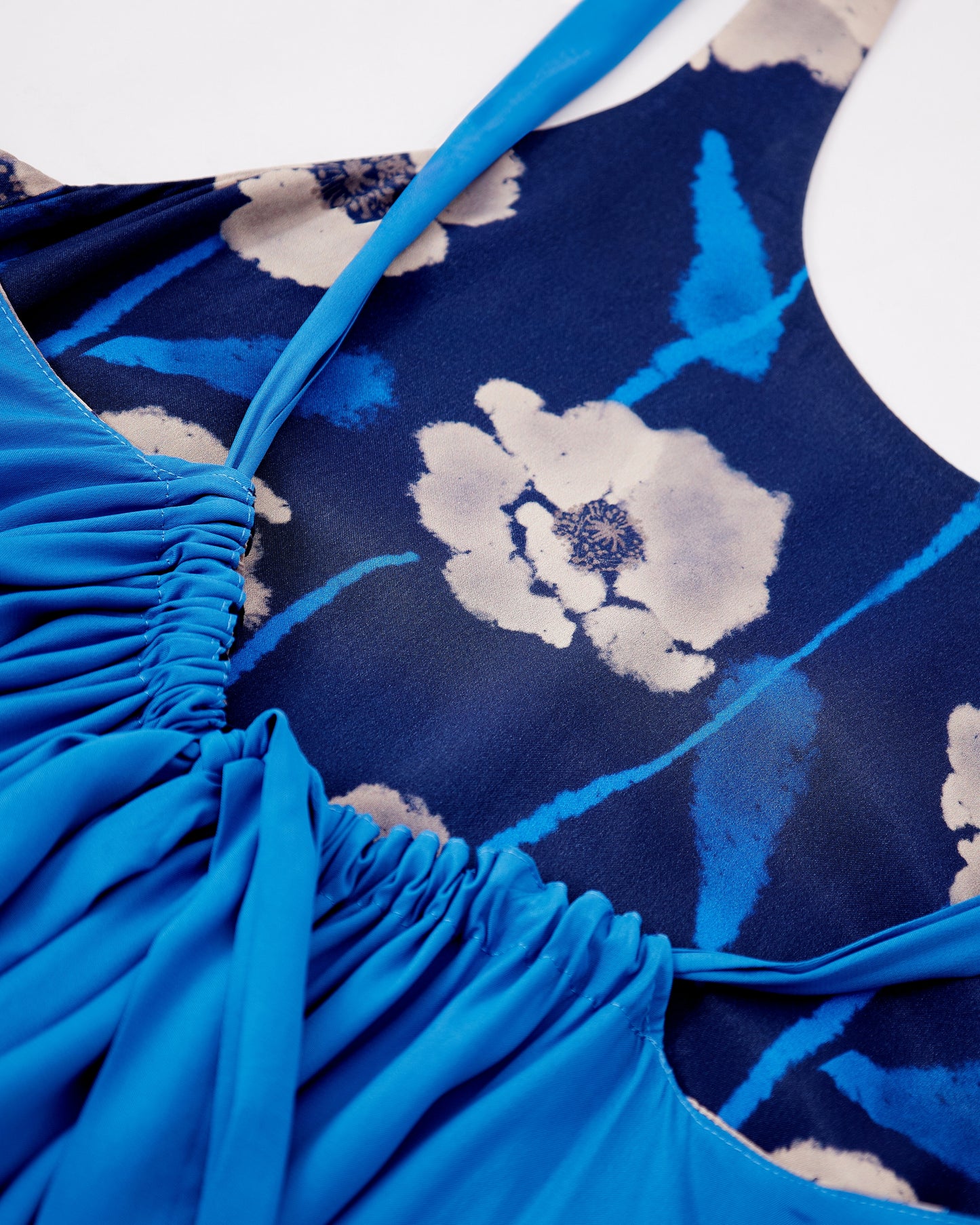 Close-up of a reversible blue floral silk blend maxi dress with poppy flowers