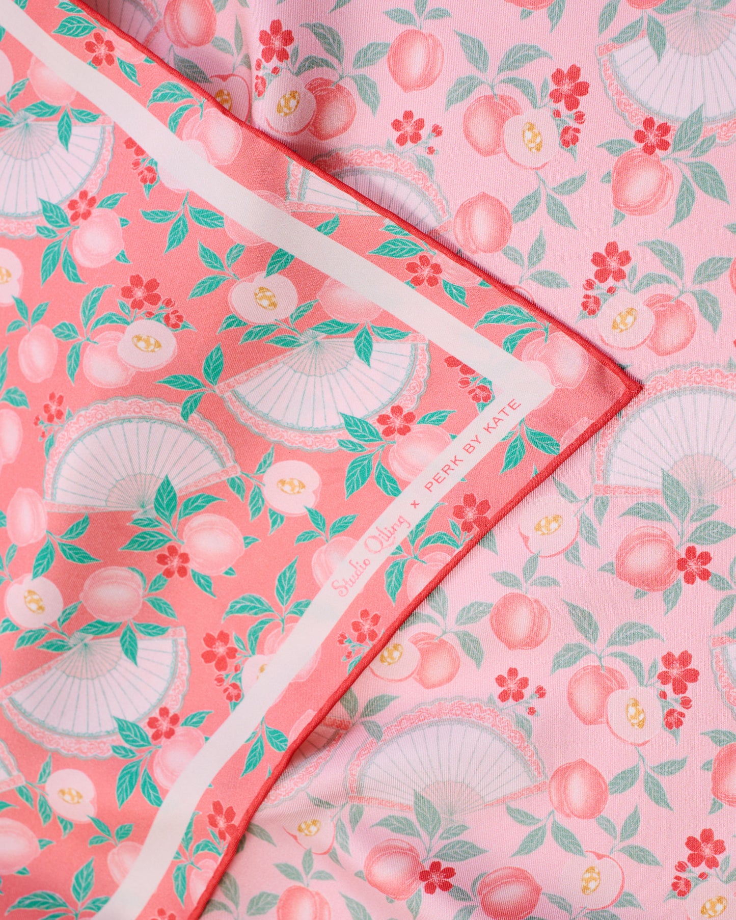 Reversible Silk Scarf in pink on one side and coral colour on the other side, with hand-drawn original prints with peaches, fan and ingots