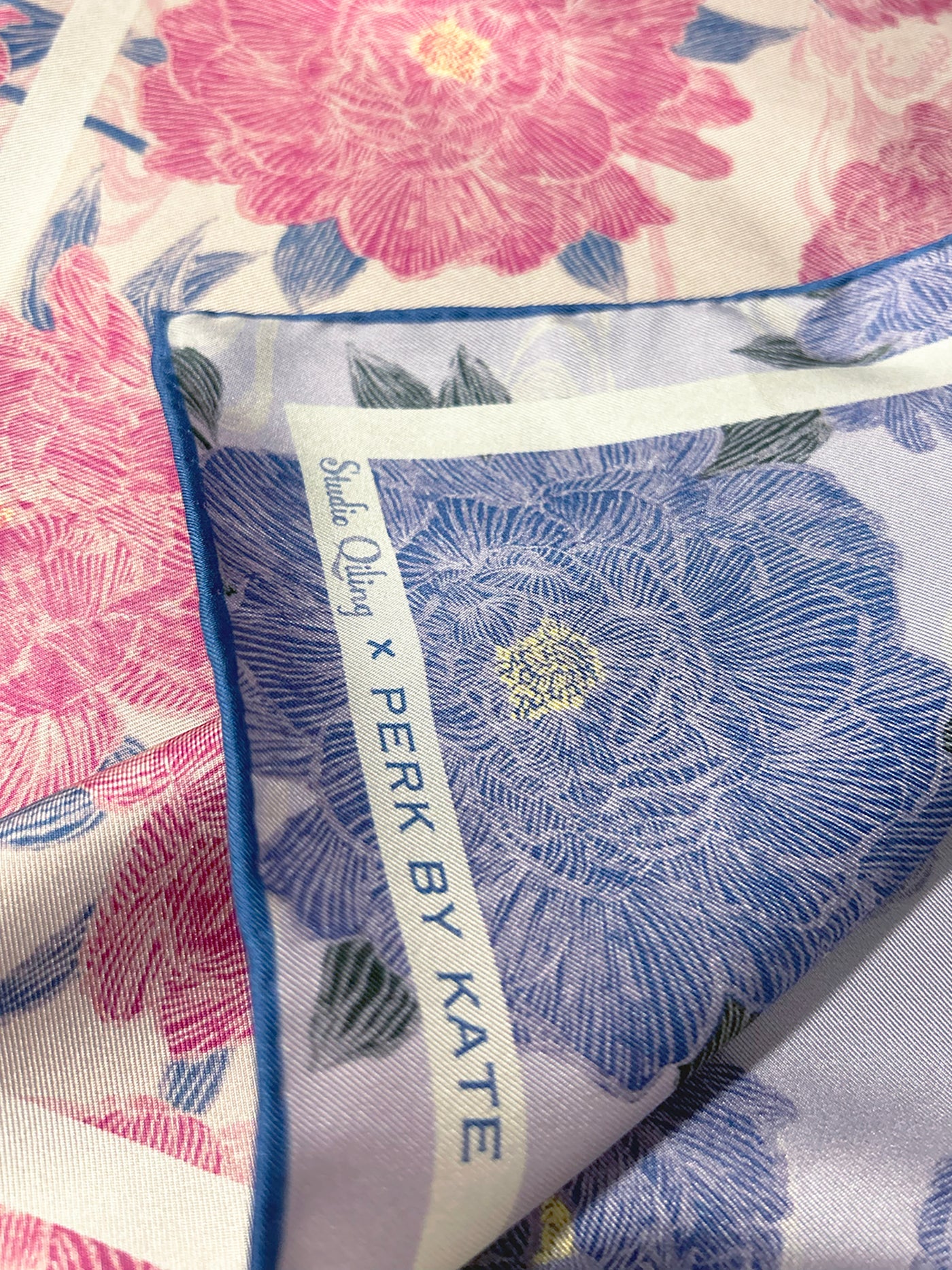 Close-up of a silk scarf with floral peony patterns