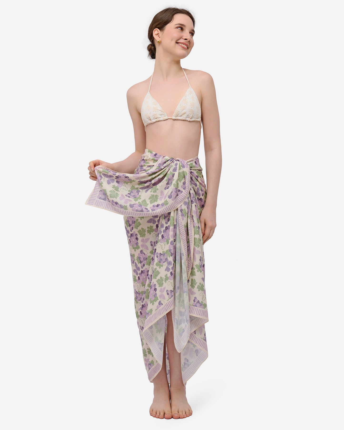 Close-up of hand-drawn amethyst grapes and butterfly print on Vanilla pareo — Studio Qiling luxury artist print beach wrap Singapore