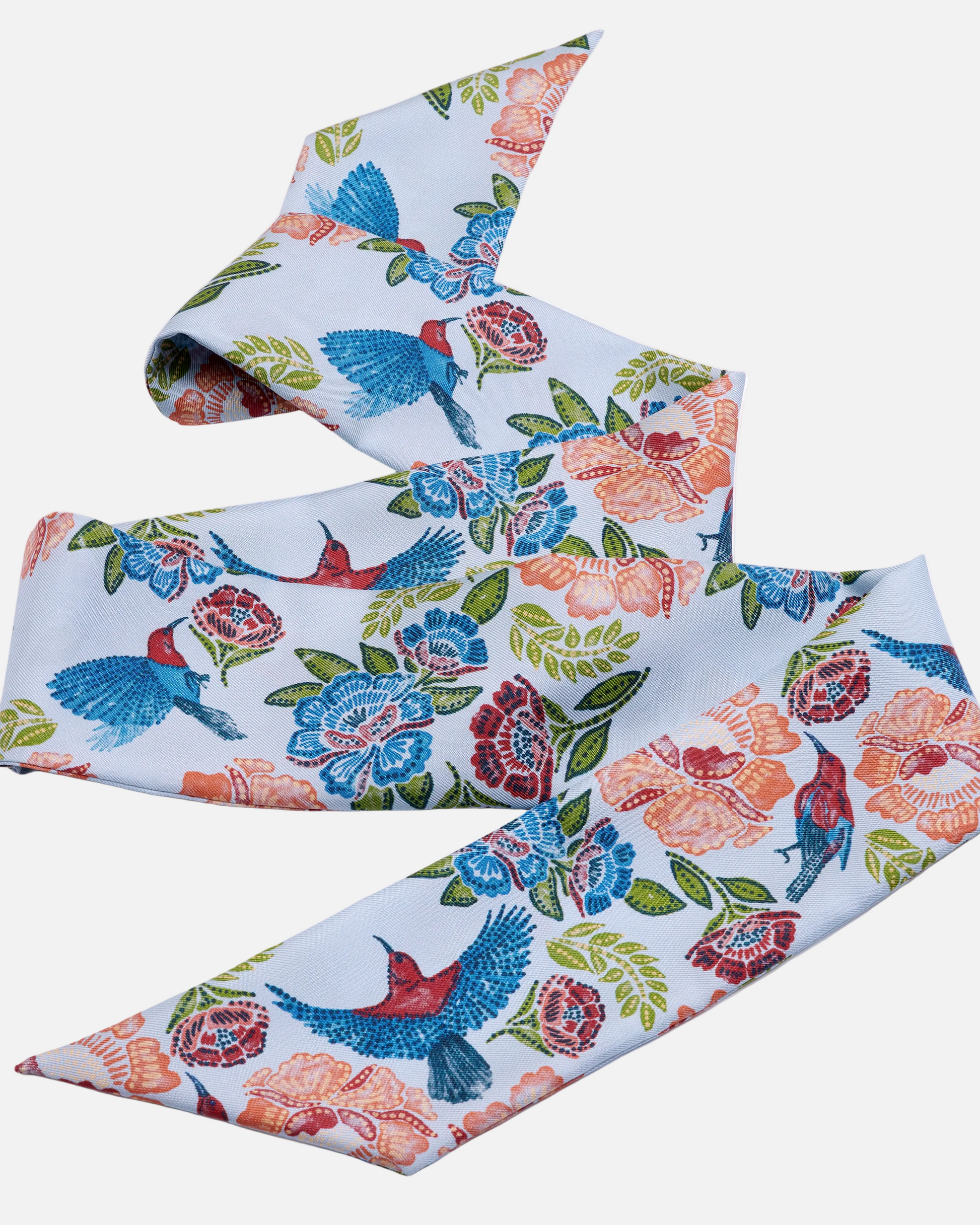 Woman wearing Crimson Sunbird Sky silk bandeau as a hair tie — Studio Qiling Singapore Sunbird batik print luxury silk bandeau