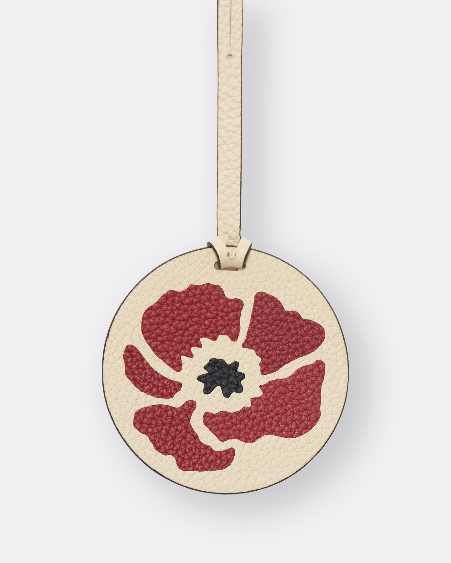Reverse of ivory poppy leather bag charm with gold foil initials personalisation