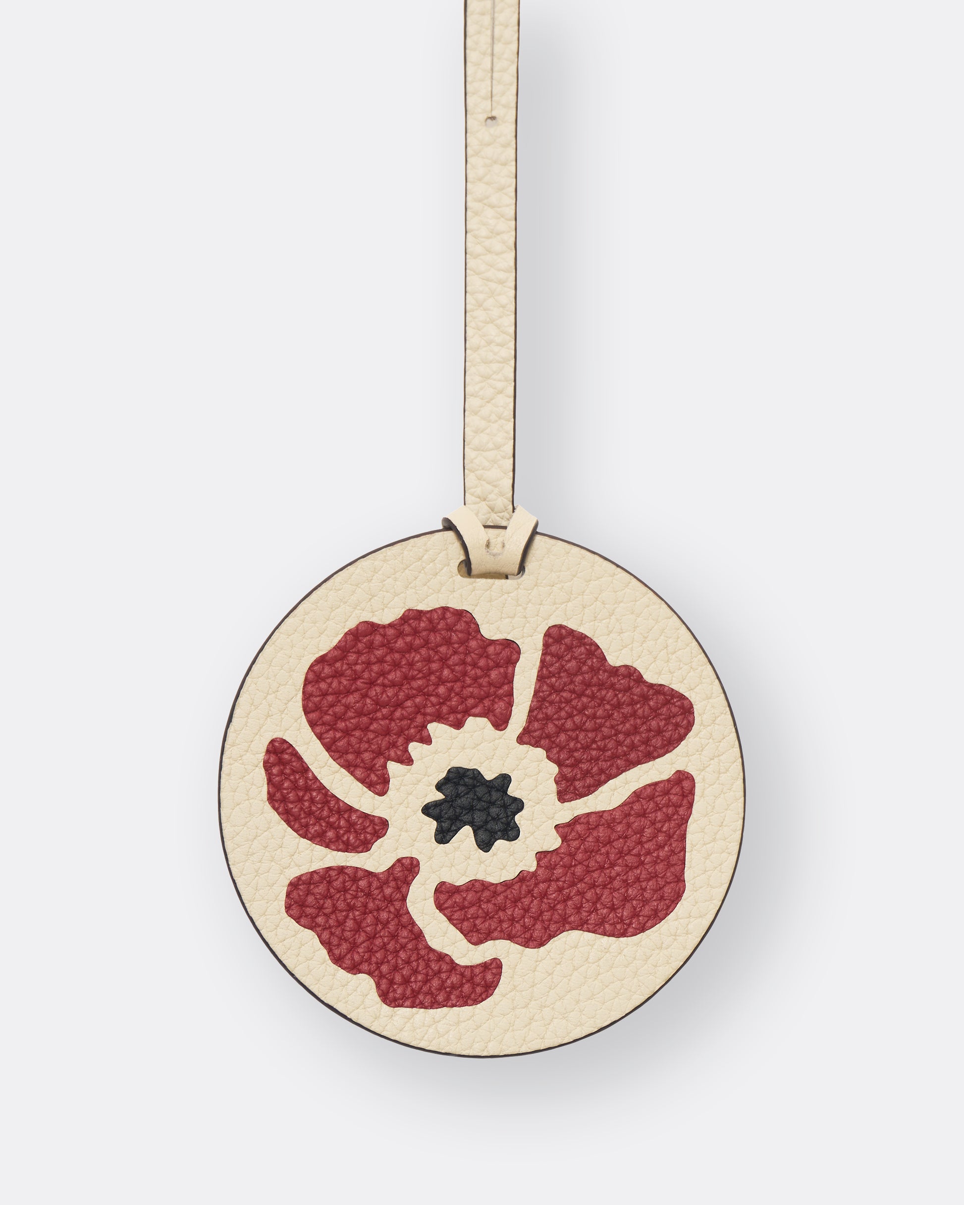 Reverse of ivory poppy leather bag charm with gold foil initials personalisation