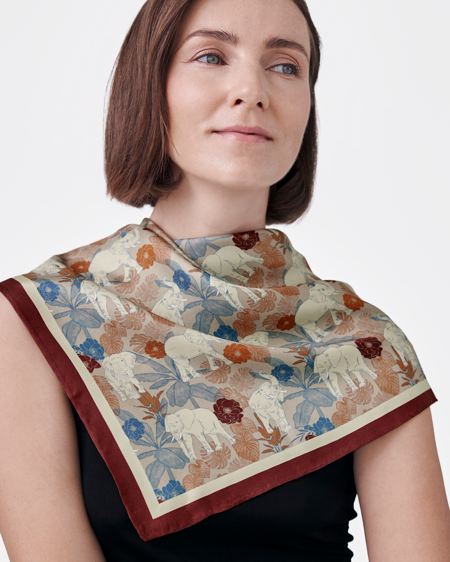 Close-up of hand-drawn elephant motif on Elephant Teal Woods reversible silk scarf — Studio Qiling Singapore designer scarf