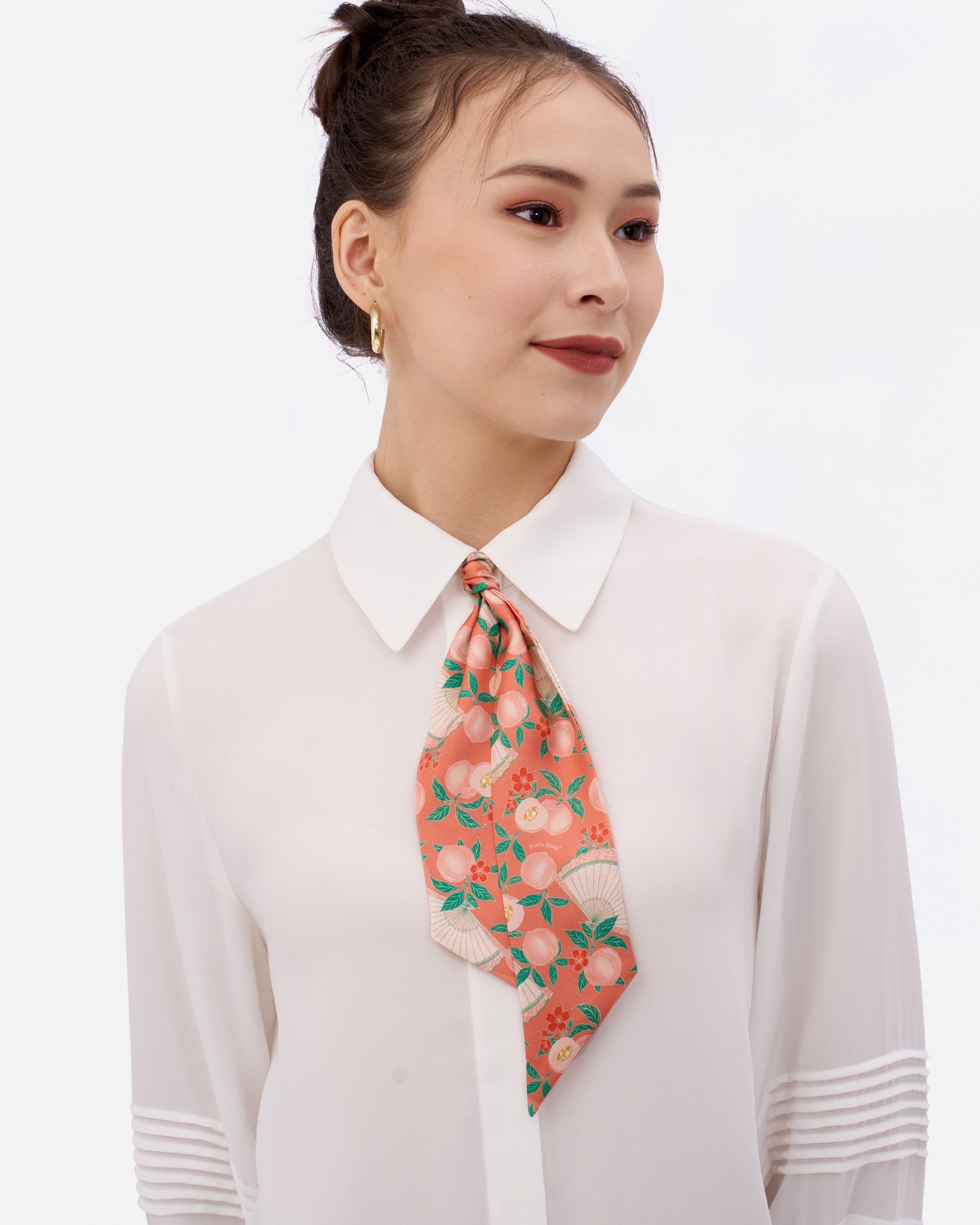 Woman wearing Golden Peaches Coral silk bandeau as a hair tie — Studio Qiling hand-drawn auspicious print luxury silk bandeau Singapore