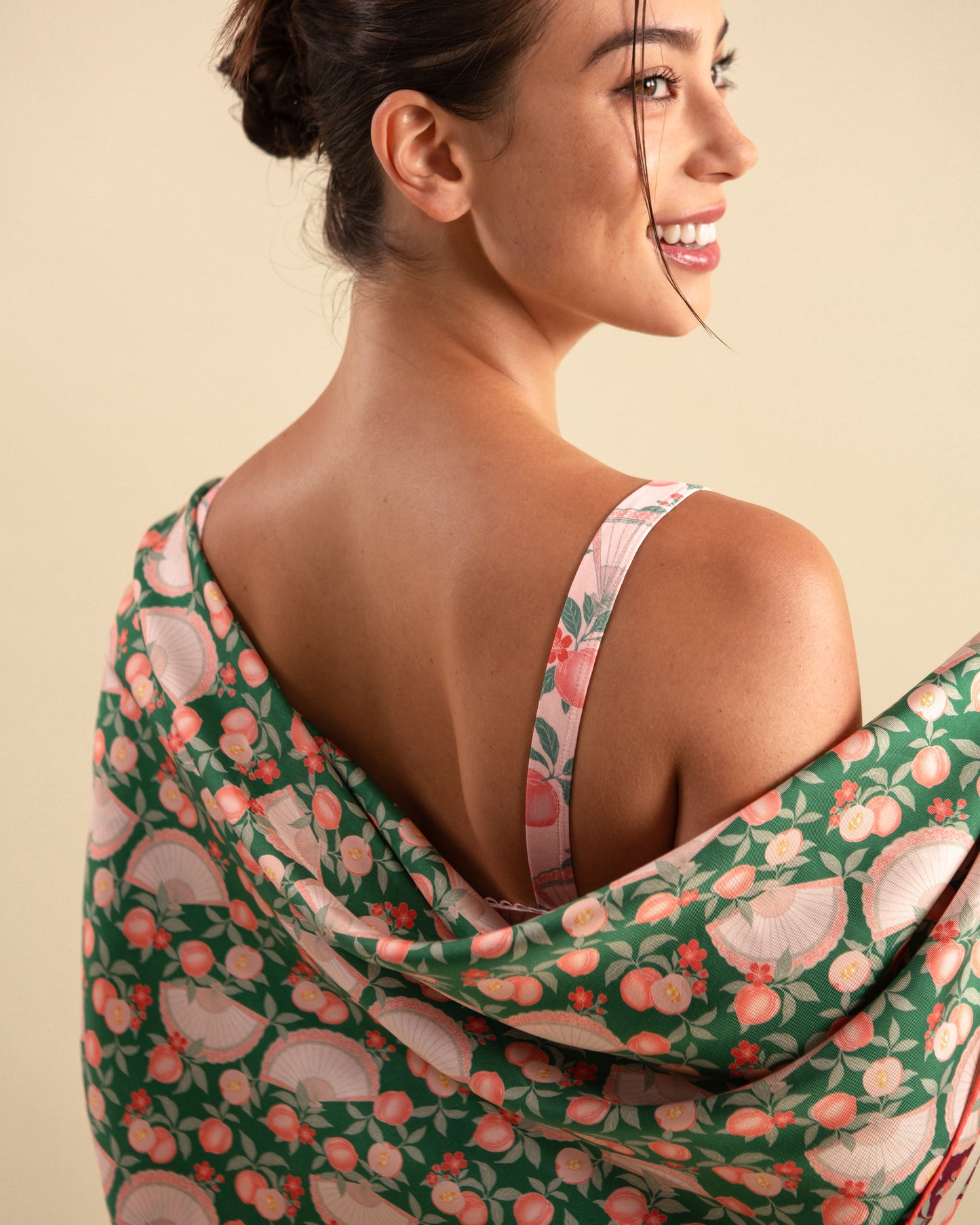 Studio Qiling x Perk by Kate. Woman draping a emerald green reversible silk scarf.