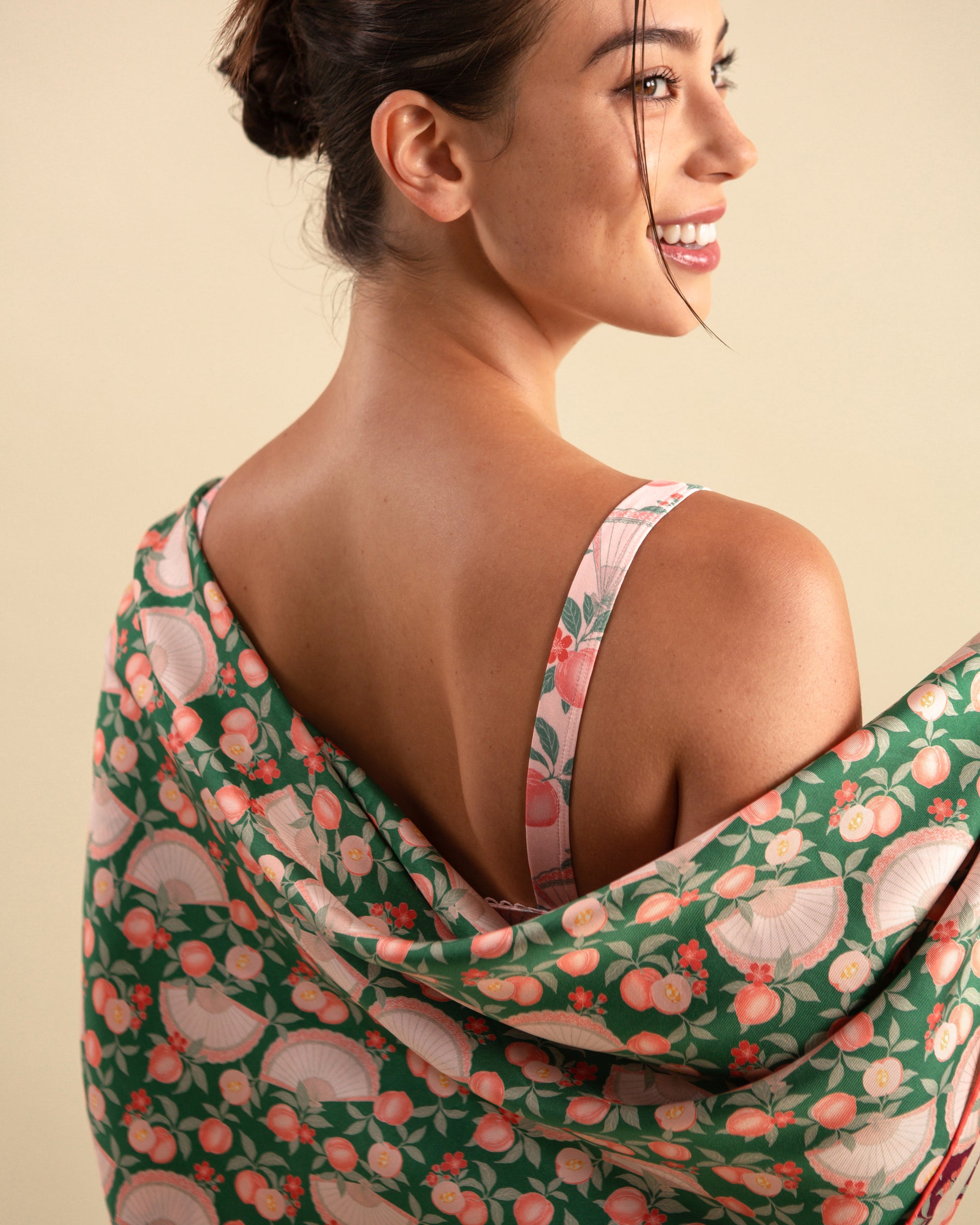 Studio Qiling x Perk by Kate. Woman draping a emerald green reversible silk scarf.