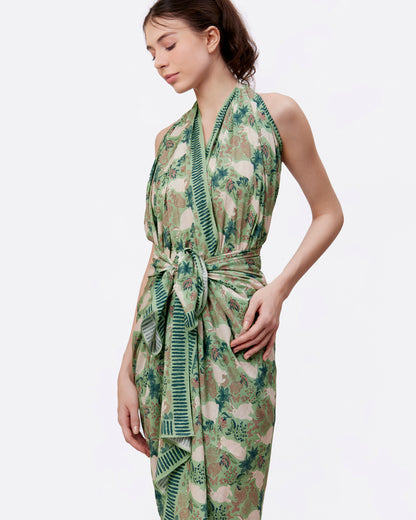 Woman wearing a green pareo or shawl as a sarong dress