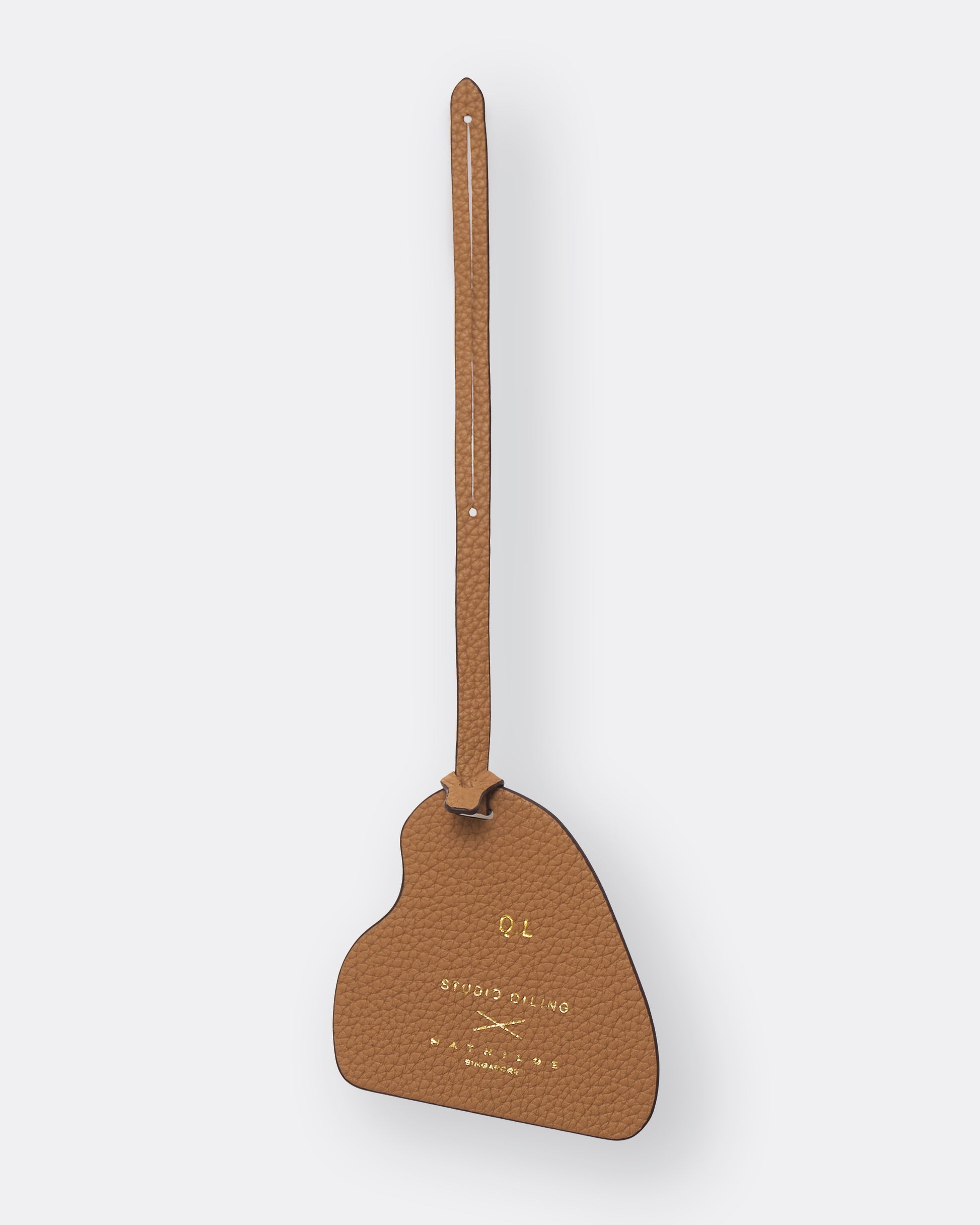 Reverse of light brown Kitsune bag charm showing gold foil initials personalisation