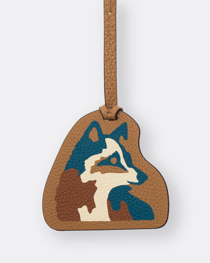 Close-up of teal and cream fox leather marquetry inlay on tan leather bag charm