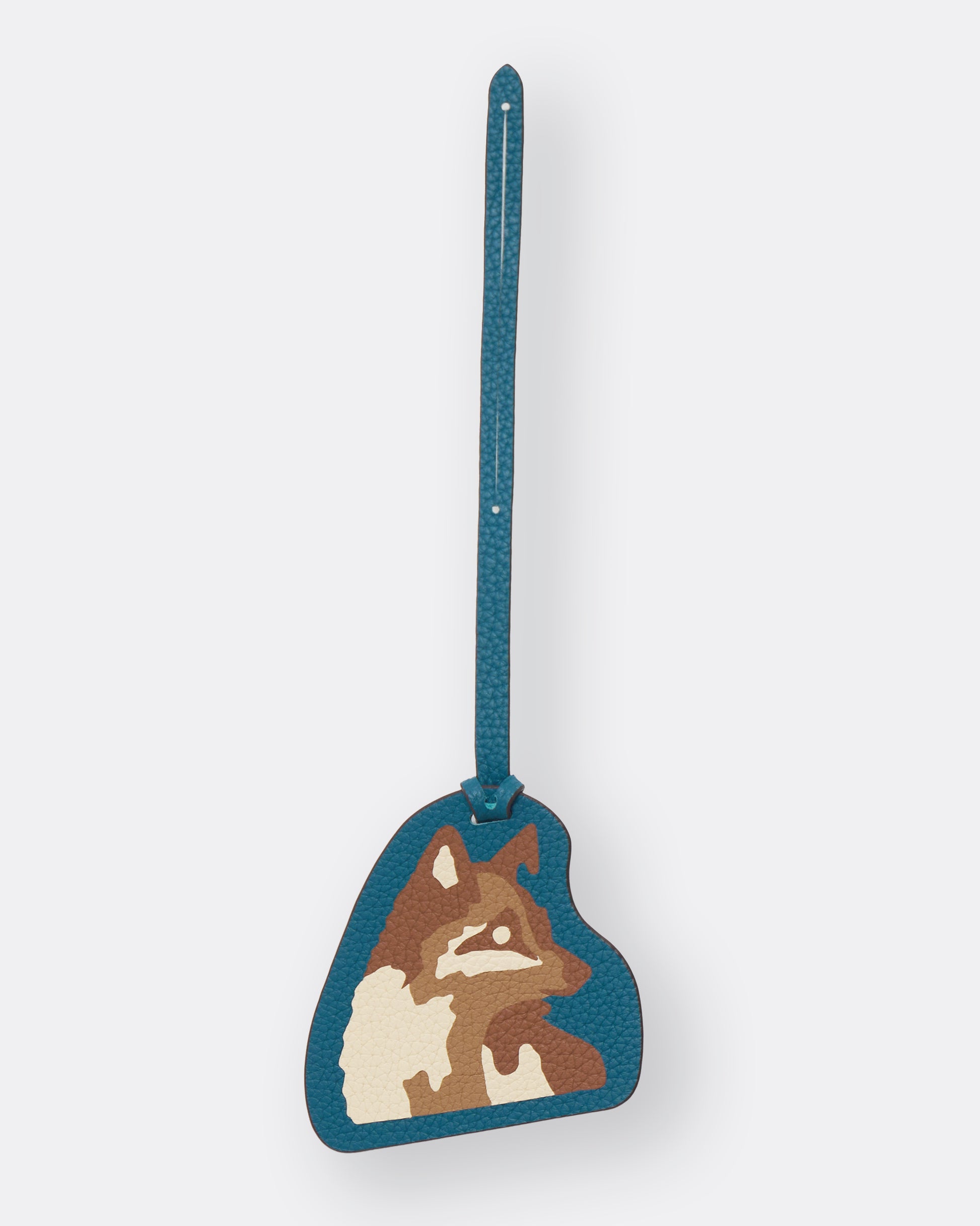 Teal leather bag charm with Kitsune fox marquetry artwork and slim leather strap, front view