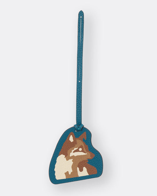 Teal leather bag charm with Kitsune fox marquetry artwork and slim leather strap, front view