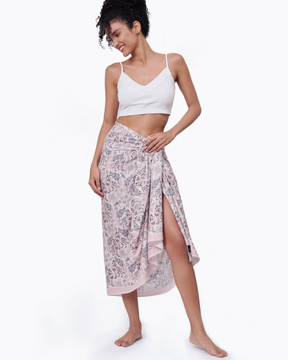Woman wearing Kitsune Pristine pareo as a halter dress — Studio Qiling hand-drawn fox spirit luxury resort pareo Singapore