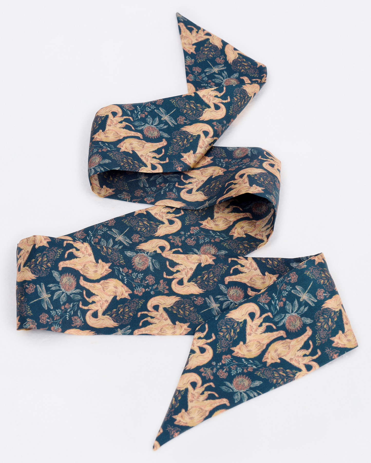 Woman wearing the Kitsune Teal Desert silk bandeau as a hair tie — Studio Qiling hand-drawn kitsune fox luxury silk bandeau Singapore