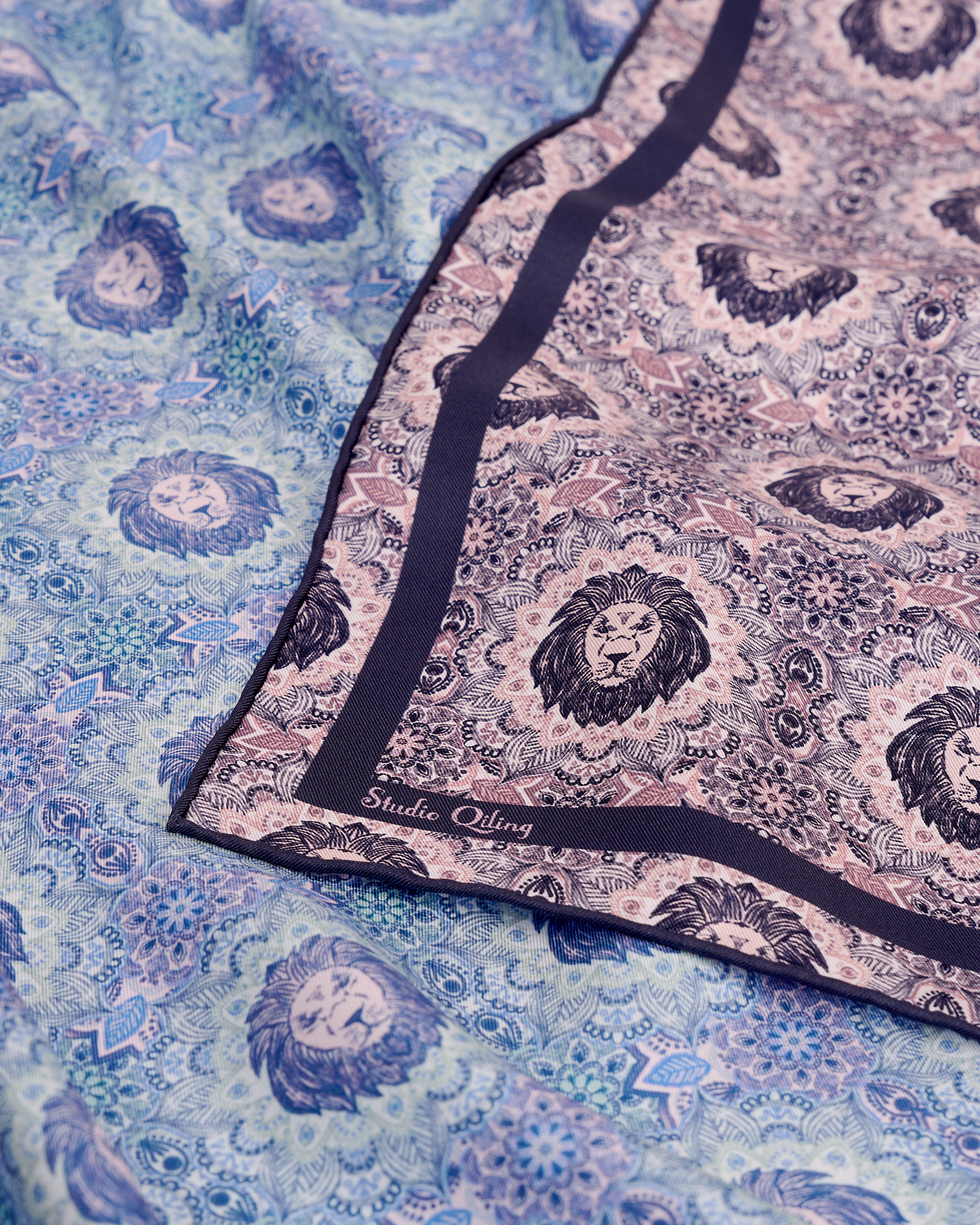 Lion Mandala Plum Frost reversible silk scarf laid flat showing both sides — Studio Qiling double-sided luxury scarf Singapore