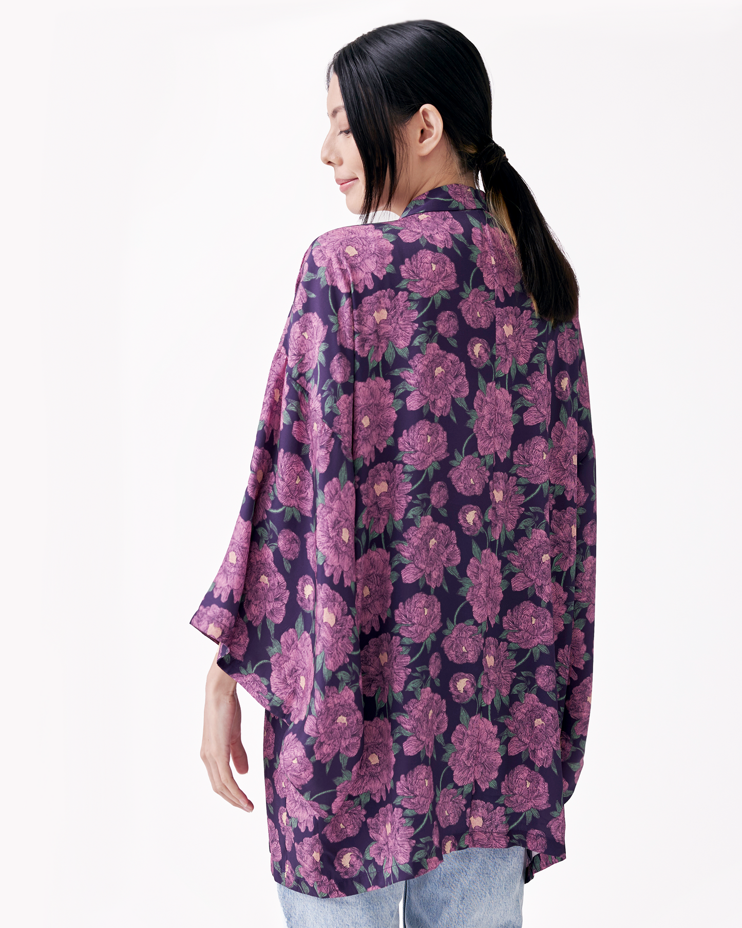 Woman wearing Peony Pink silk blend kimono open over a white dress — Studio Qiling hand-drawn peony print artist kimono Singapore