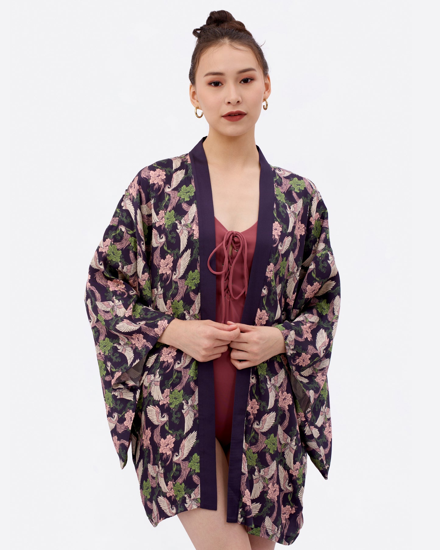 Woman wearing a kimono-style beach and pool cover up over a swimsuit.