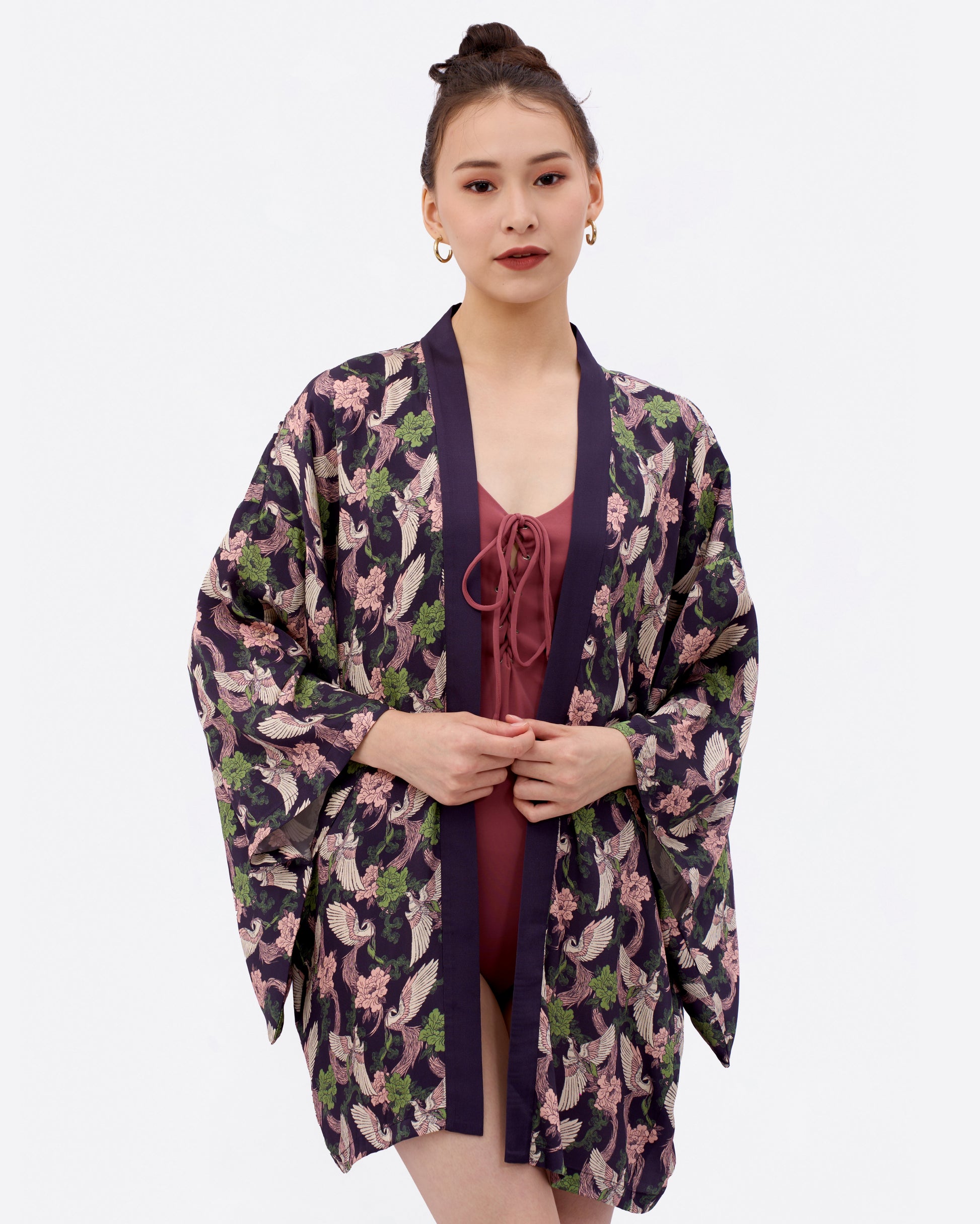 Woman wearing a kimono-style beach and pool cover up over a swimsuit.