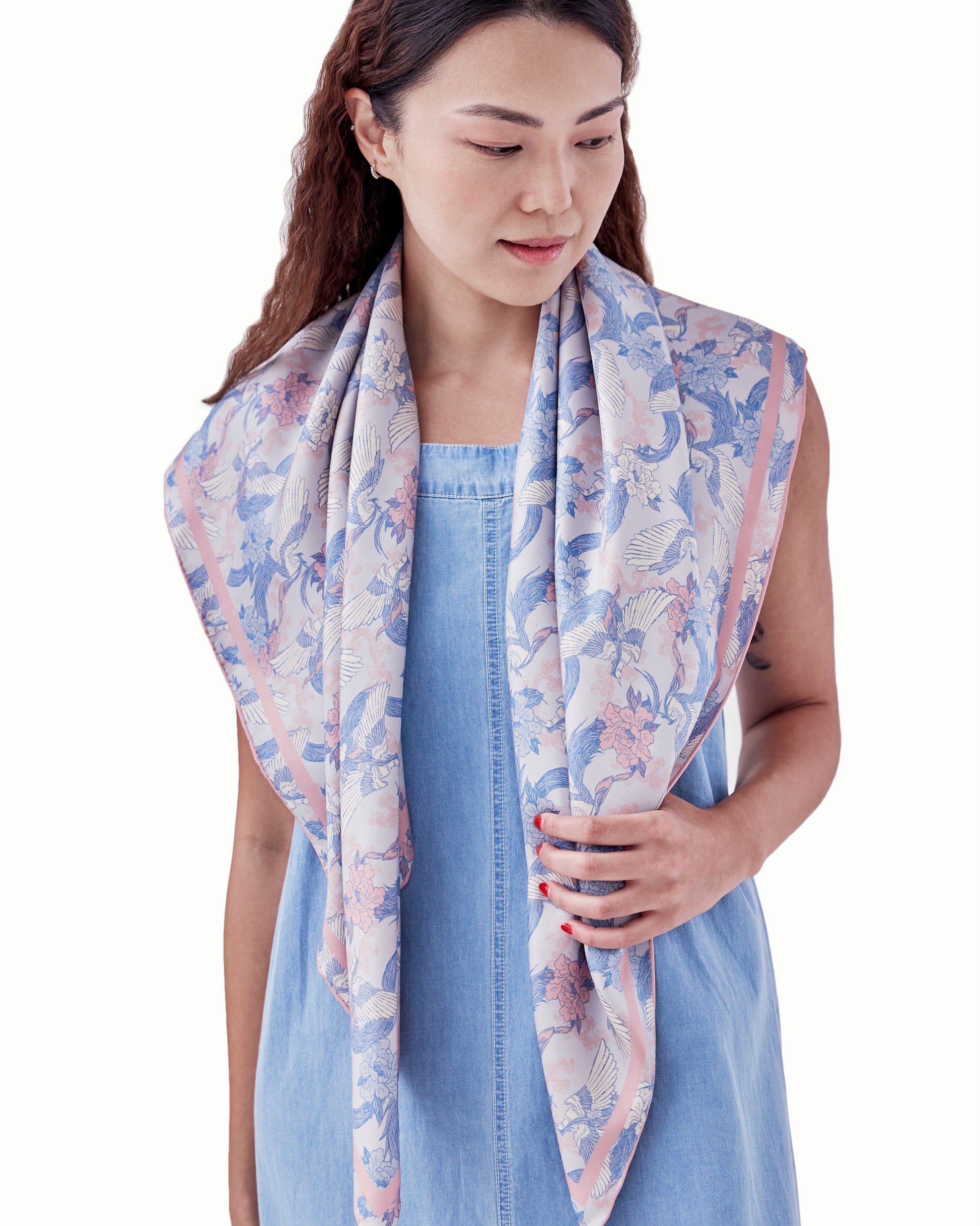 Woman wearing Phoenix Sakura Sky reversible silk scarf as a neck wrap — Studio Qiling hand-drawn phoenix print luxury scarf