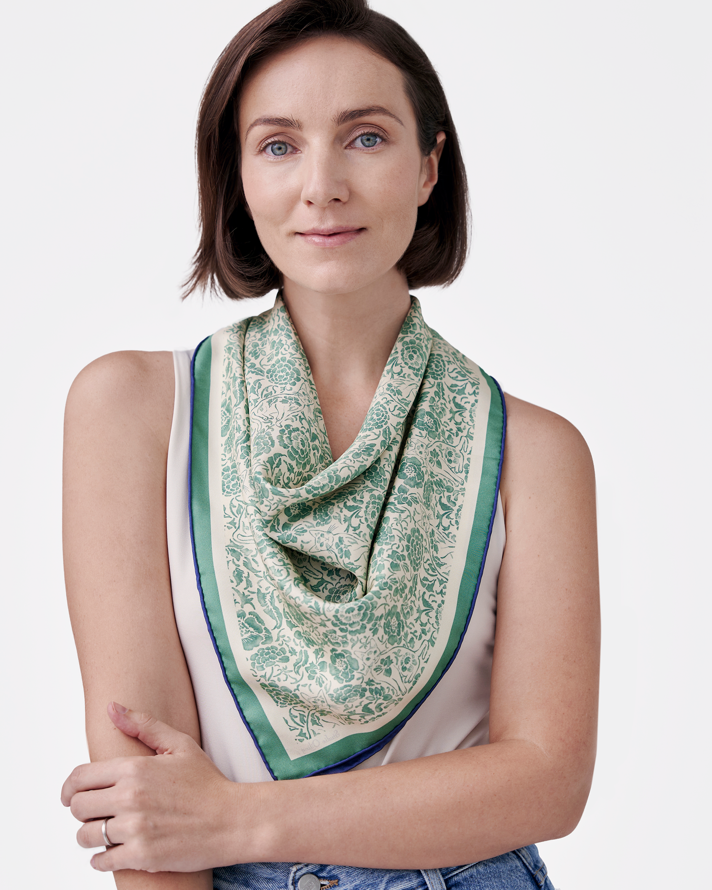 Woman wearing Porcelain Cat Classic Green reversible silk scarf as a neck wrap — Studio Qiling Peranakan heritage luxury scarf Singapore