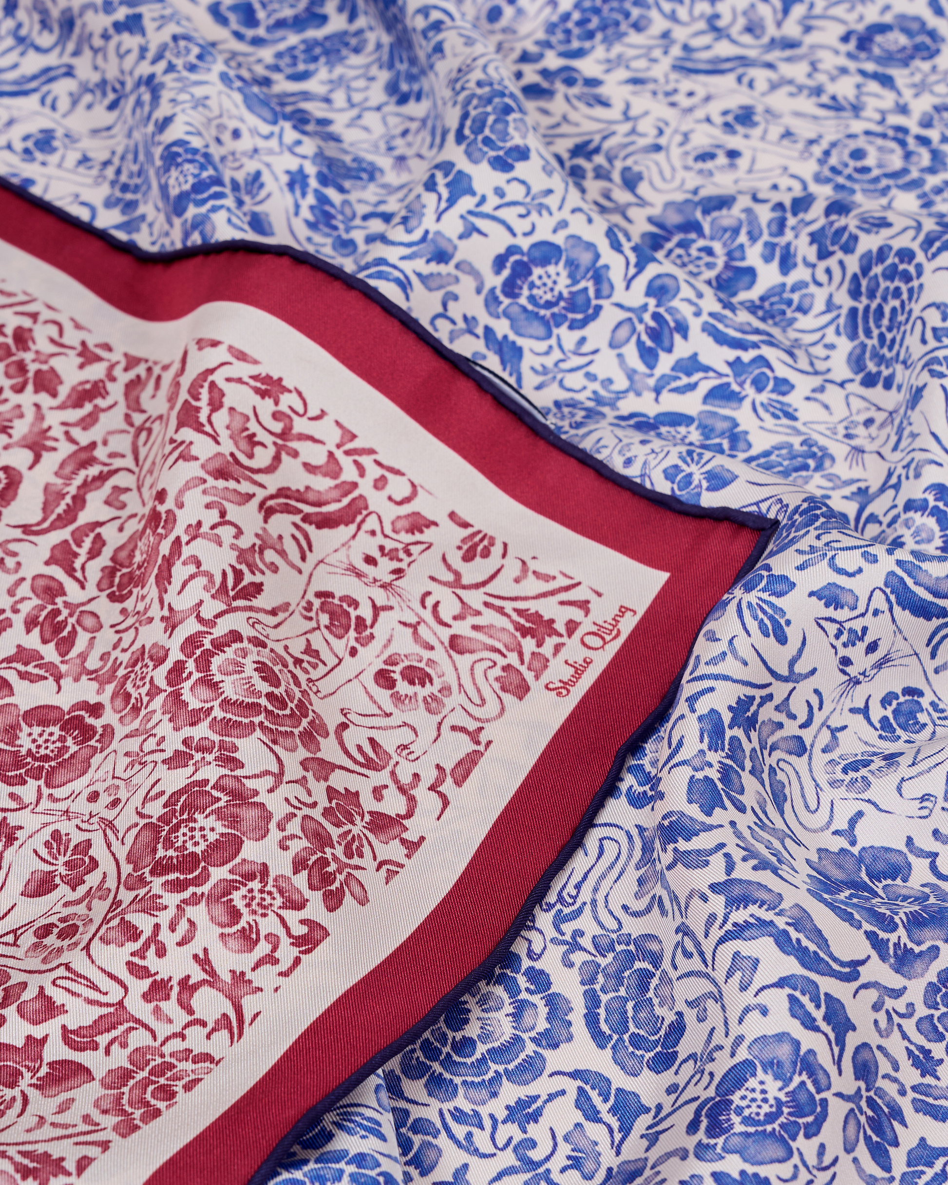 Porcelain Cat Classic Red reversible silk scarf laid flat showing both sides — Studio Qiling double-sided luxury scarf Singapore