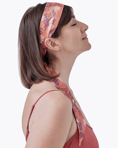Woman wearing Qiling Mauve silk bandeau as a hair tie — Studio Qiling hand-drawn Qilin print luxury silk bandeau Singapore