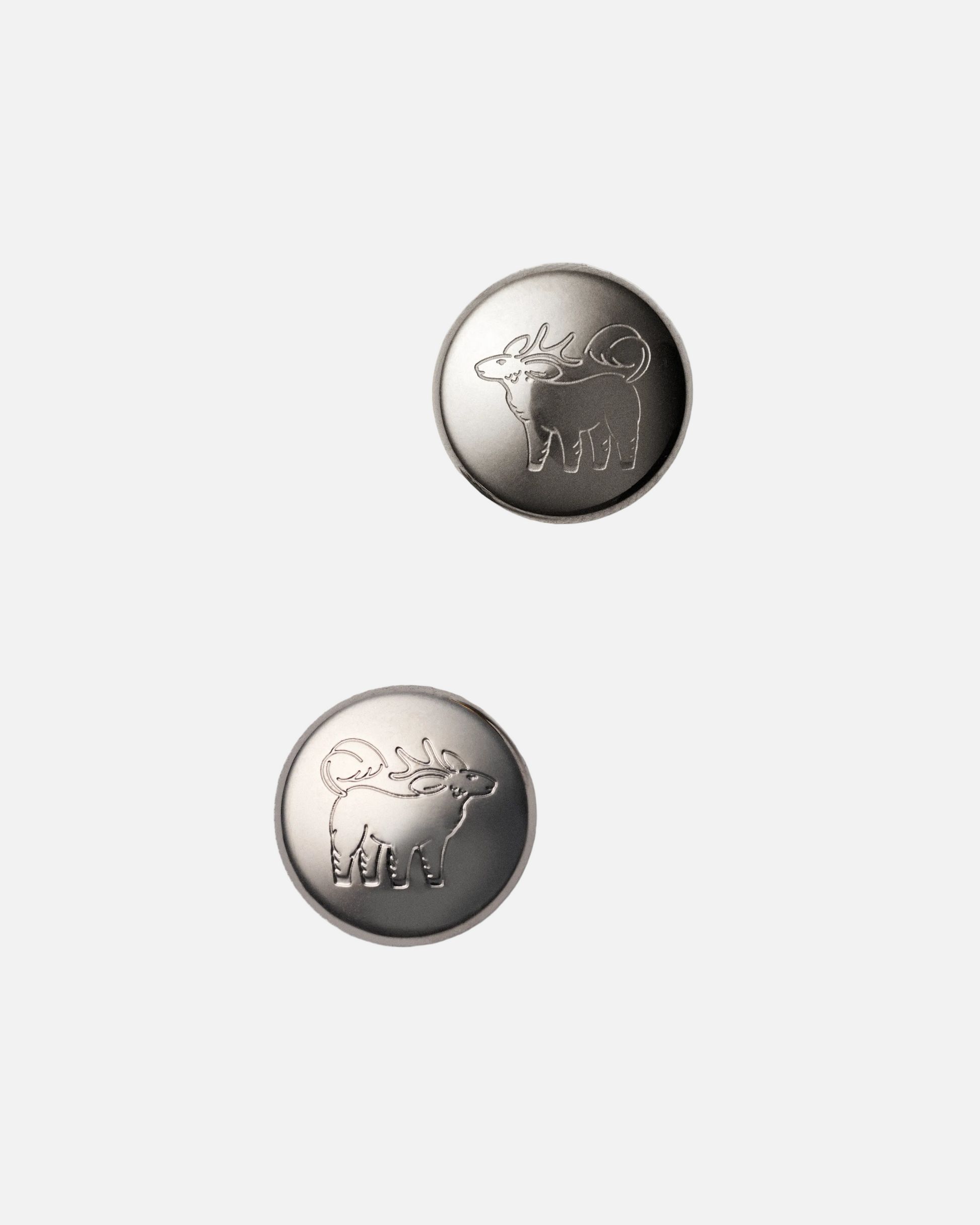Qiling Pebble stud earrings in palladium-plated stainless steel with engraved Qiling emblem — Studio Qiling designer jewellery Singapore