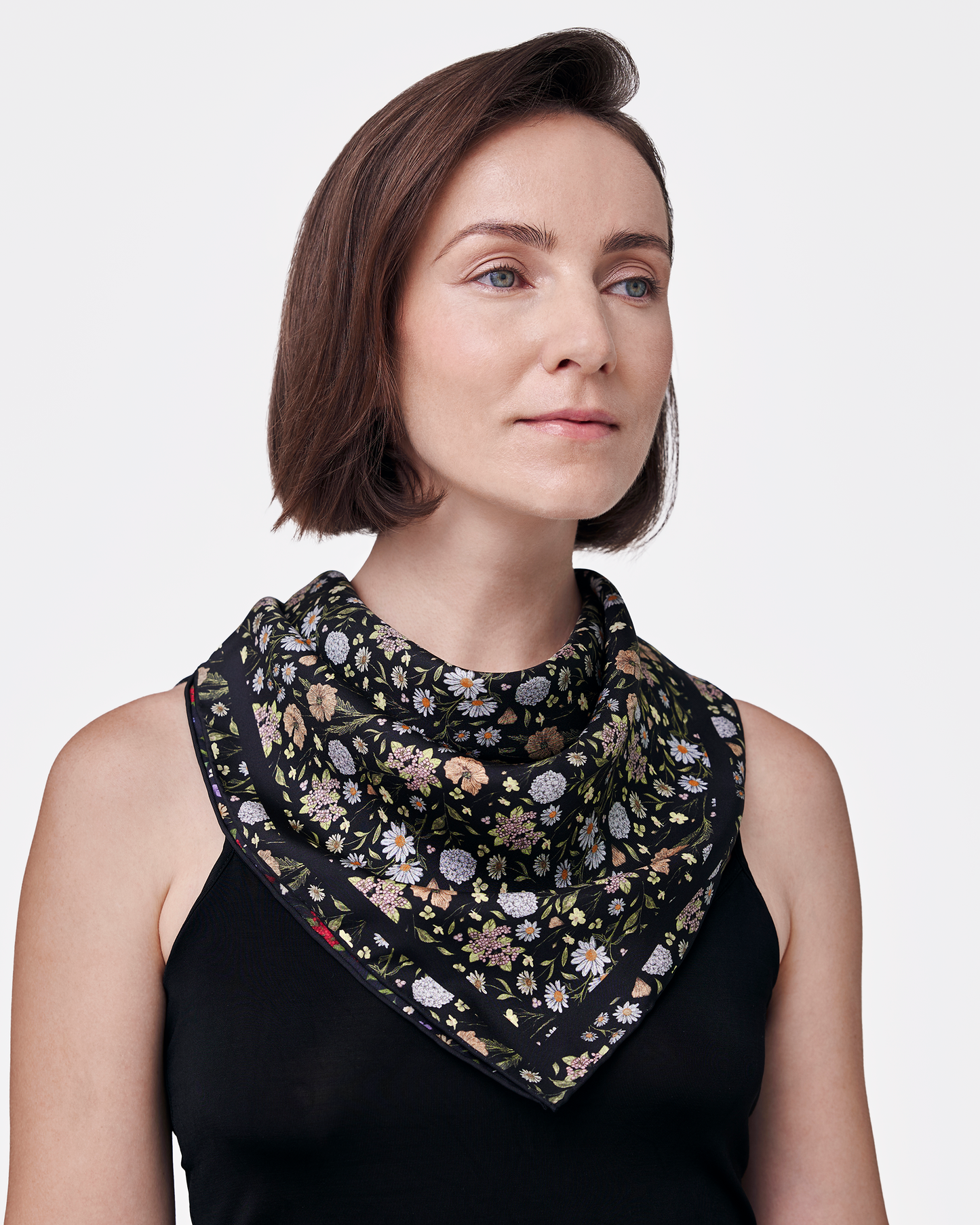 Woman wearing Rustic Bloom Caviar Navy reversible silk scarf as a neck wrap — Studio Qiling hand-drawn floral luxury scarf