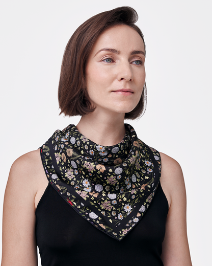 Woman wearing Rustic Bloom Caviar Navy reversible silk scarf as a neck wrap — Studio Qiling hand-drawn floral luxury scarf
